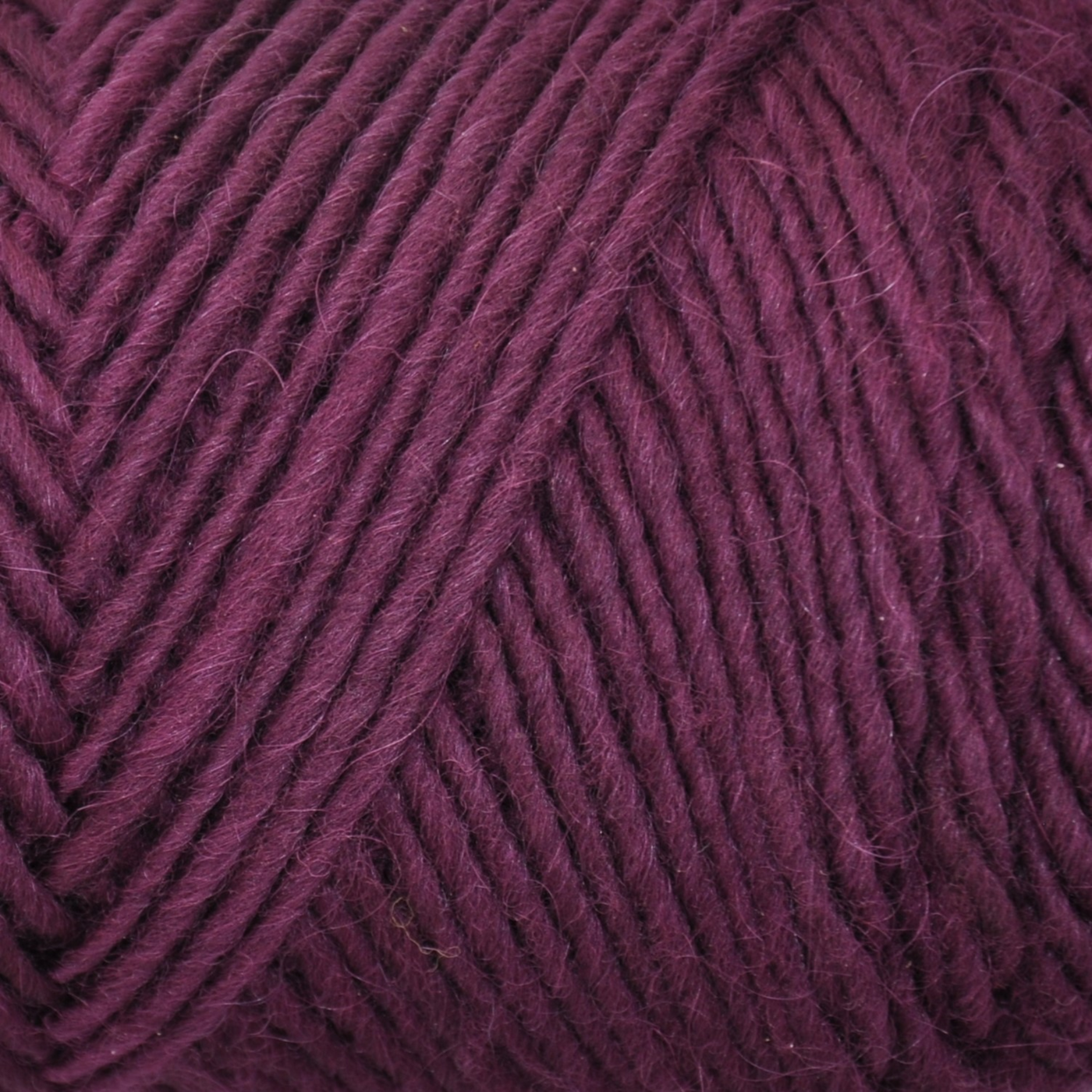 Brown Sheep Lamb’s Pride Bulky yarn skein, Wild Lilac deep purple colorway close-up