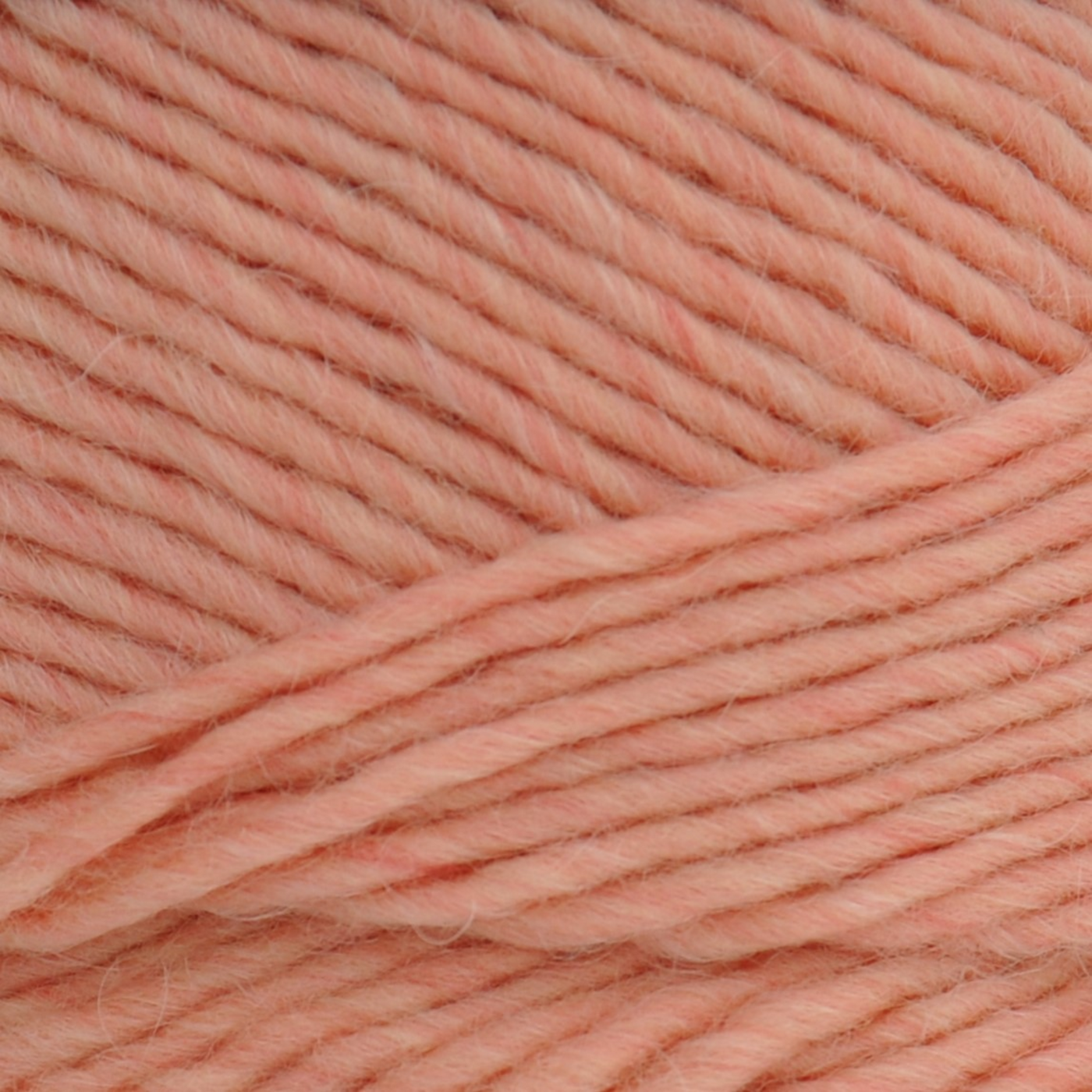 Brown Sheep Lamb’s Pride Worsted wool-mohair yarn close-up in Guava peach — available at Revolution Fibers