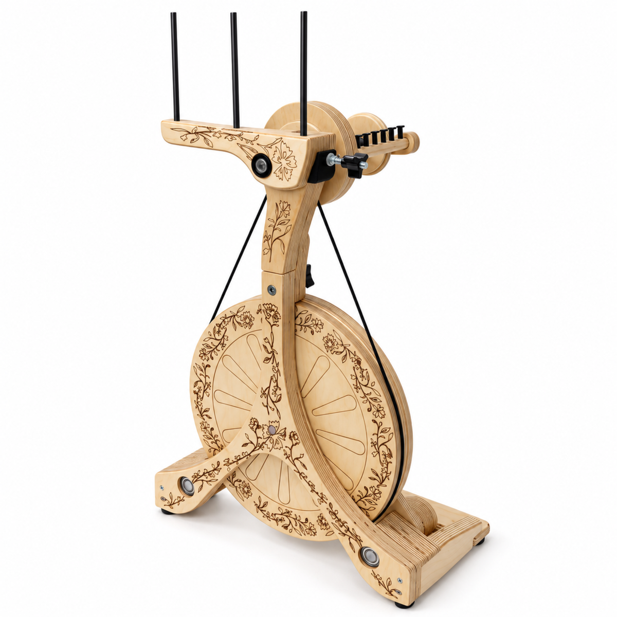 Three-quarter view of the SpinOlution Pollywog spinning wheel featuring floral engraving, natural wood construction, and double treadles.