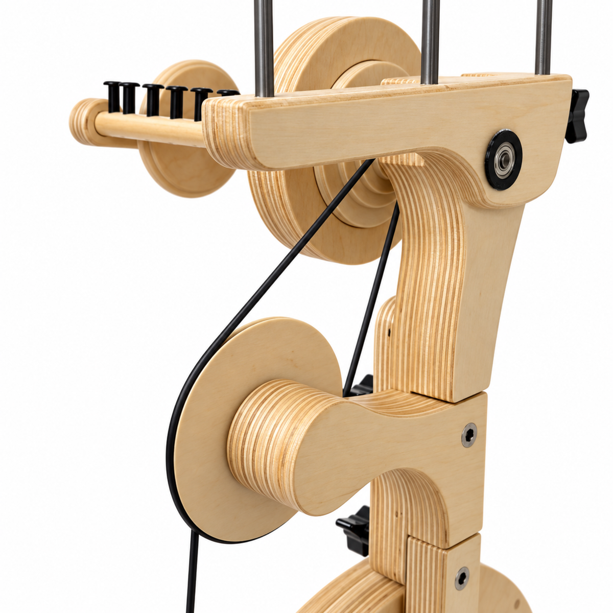 Close-up of the SpinOlution Pollywog flyer assembly showing the wooden bobbin, flyer arms, hooks, and drive band.