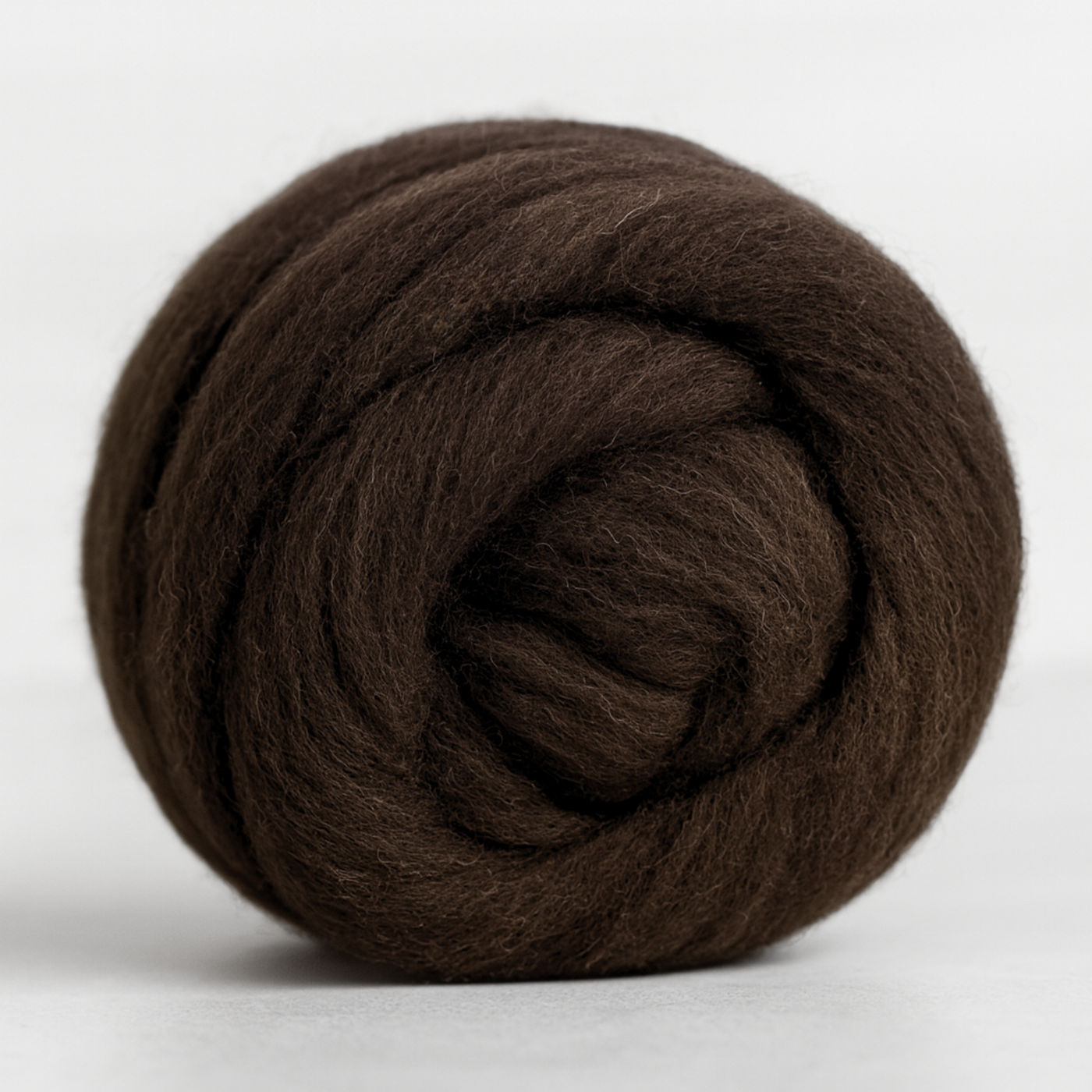 Coiled bundle of natural brown Corriedale combed top—undyed 28-micron wool prepared for hand-spinning on wheel or drop spindle.