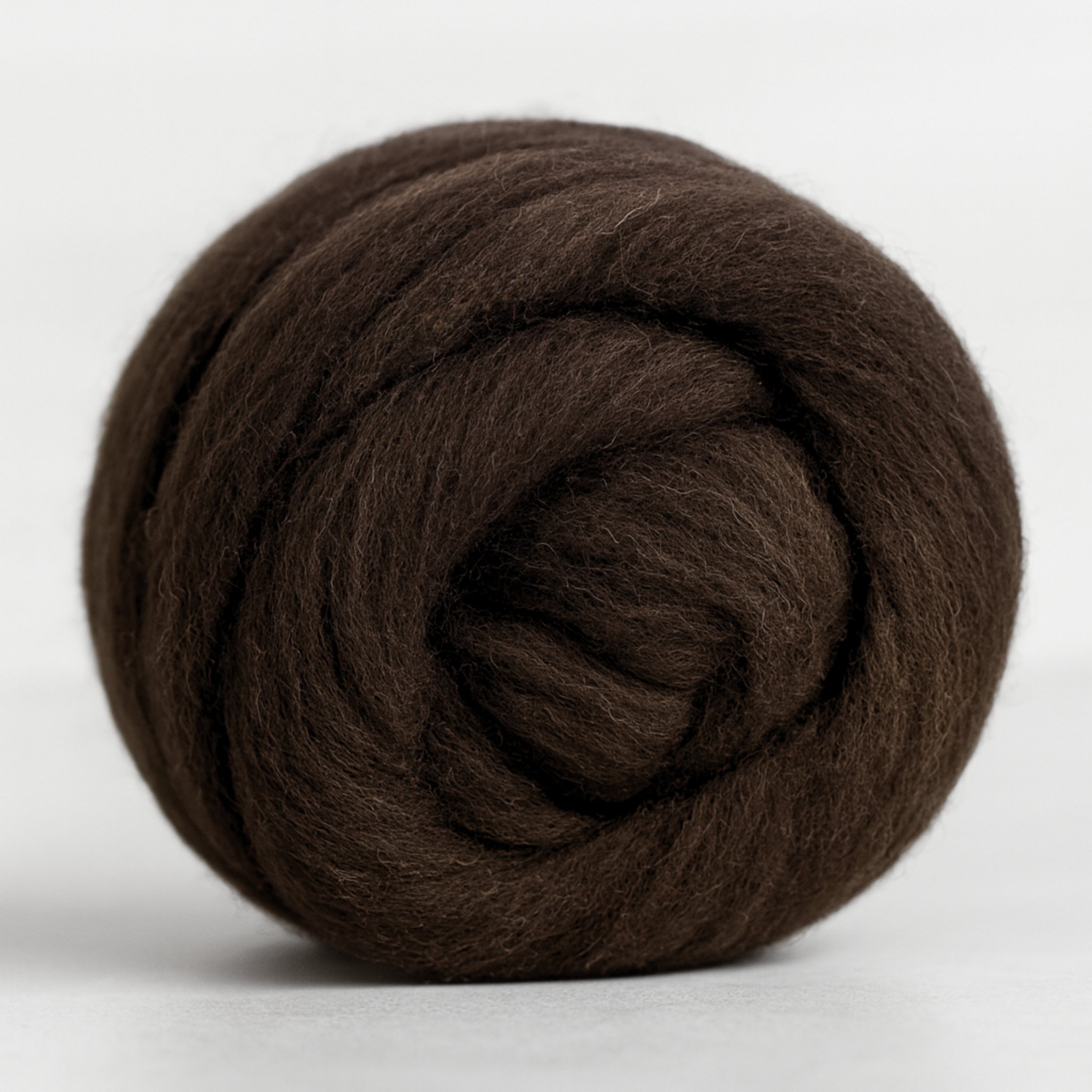 Coiled bundle of natural brown Corriedale combed top—undyed 28-micron wool prepared for hand-spinning on wheel or drop spindle.