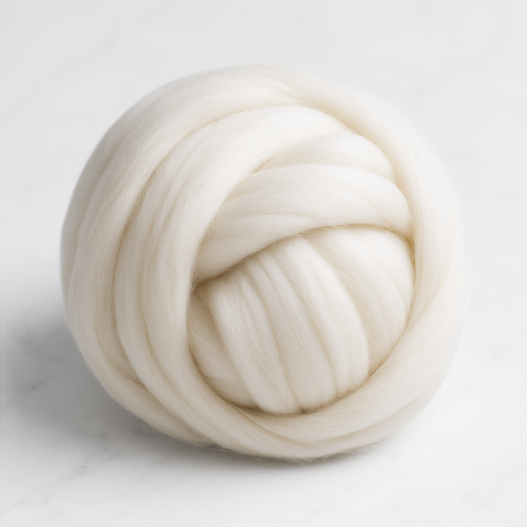 Coiled bundle of undyed ivory Merino combed top—clean, dye-ready 1 lb roving for drop spindle or wheel, needle felting, and tapestry weaving.