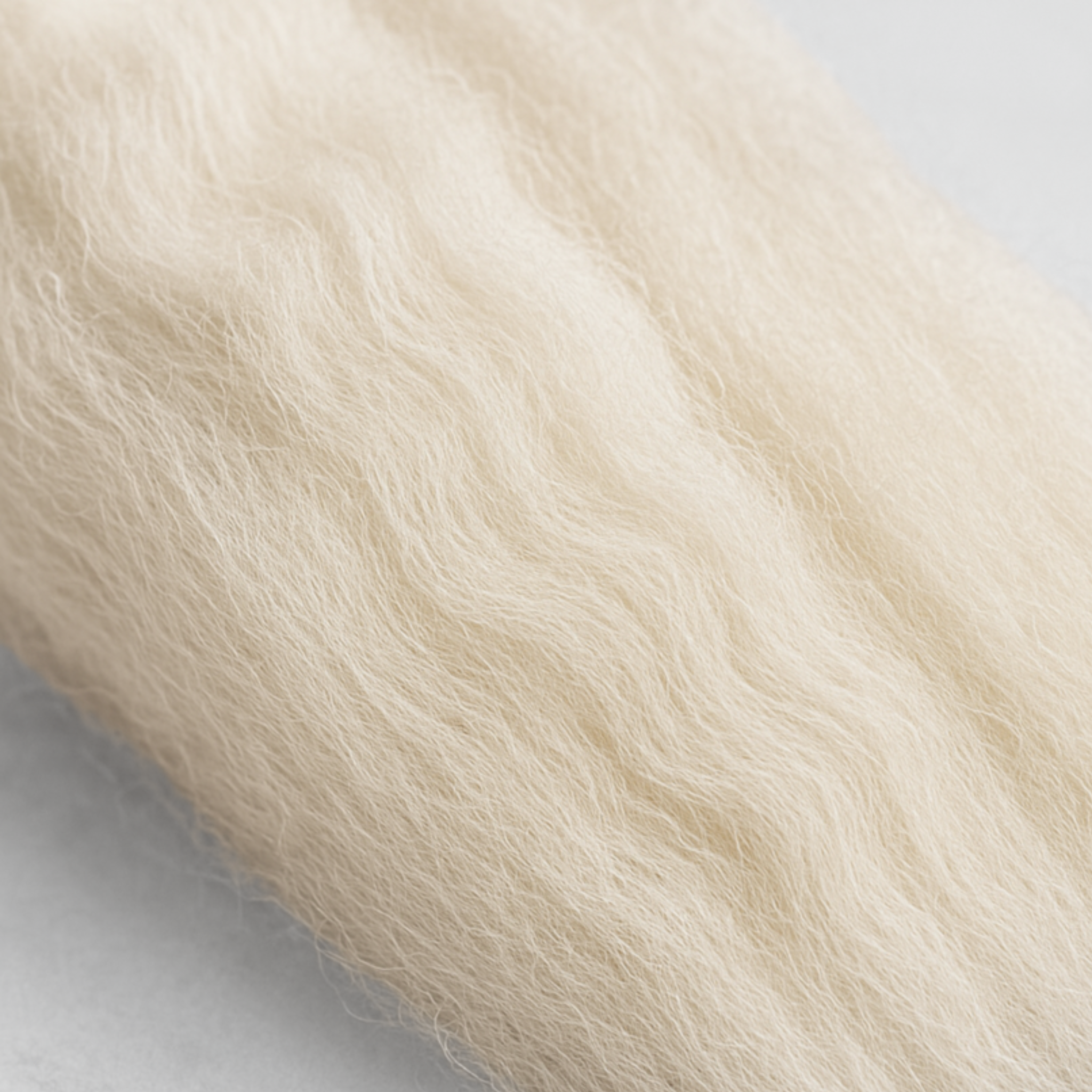 Close-up texture of Corriedale combed top—natural crimp and aligned fibers for smooth, controlled drafting; undyed cream wool.