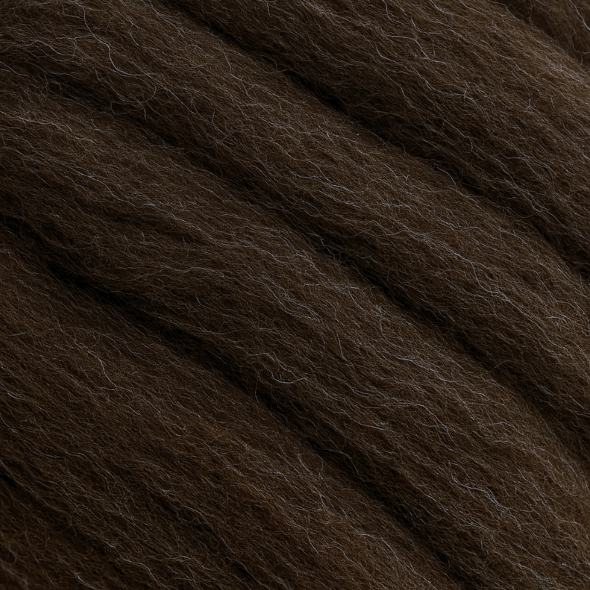 Macro close-up of Corriedale fiber showing uniform crimp and aligned staples—natural brown, 28-micron combed top for smooth drafting.