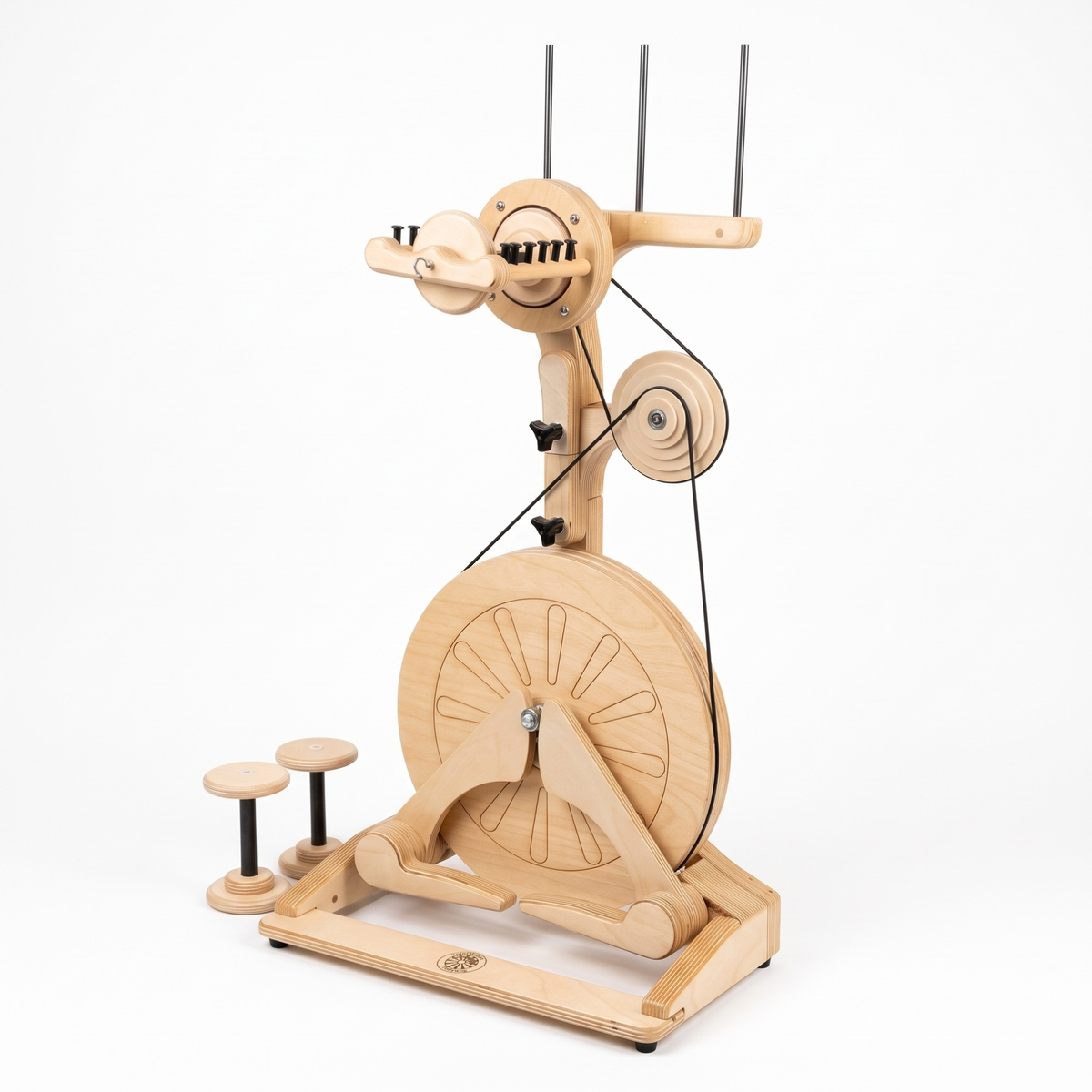 Three-quarter view of the SpinOlution Pollywog spinning wheel showing its compact wooden frame, flyer assembly, drive wheel, and built-in lazy kate.