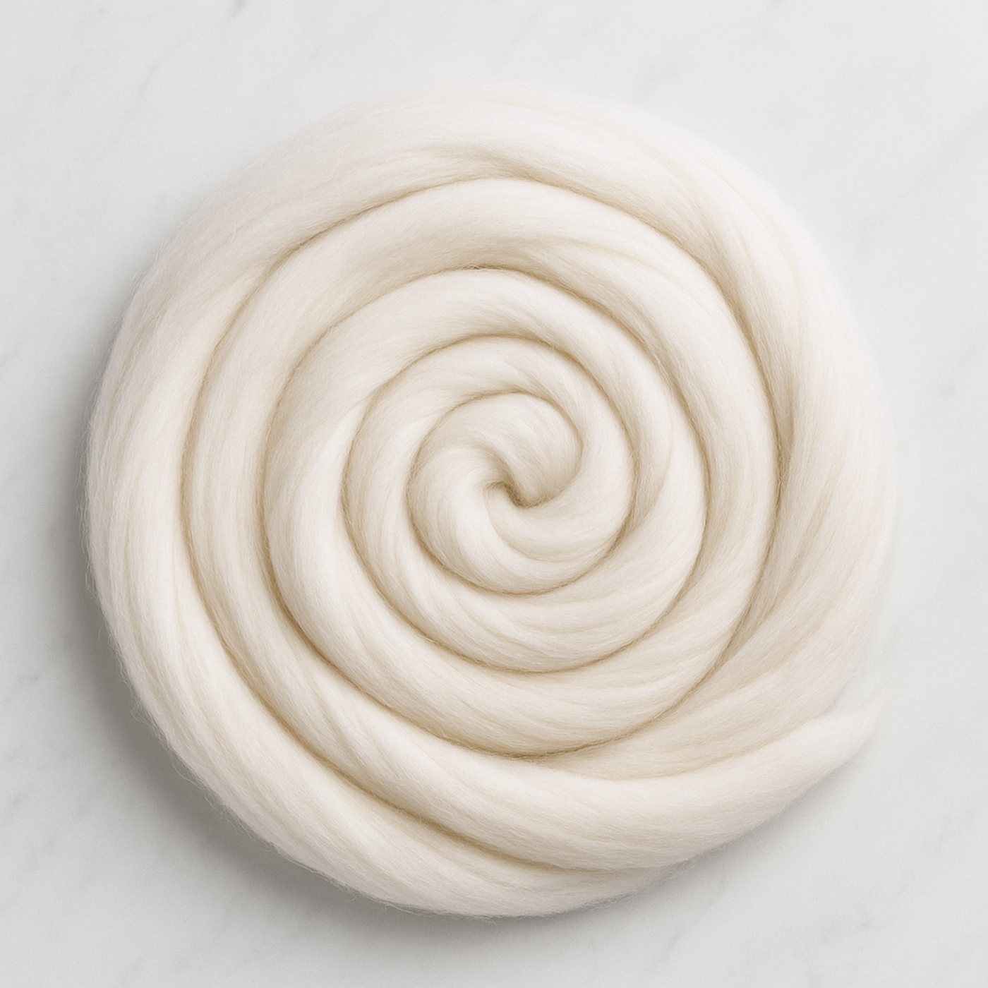 Spiral coil of undyed Merino roving top—silky hand, gentle drape, and great dye uptake for custom colorways.
