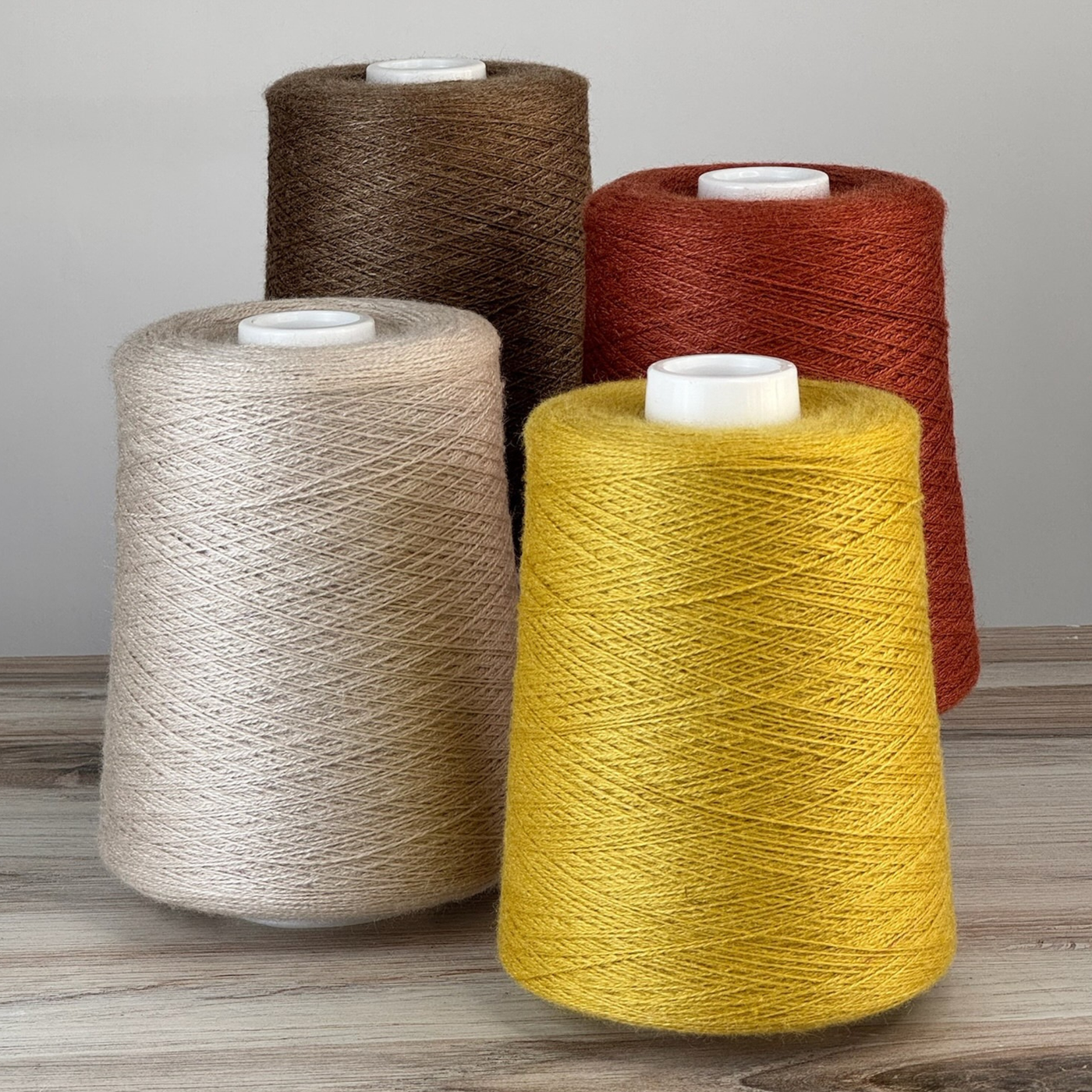 Warm brown and vanilla cones flanking vivid chartreuse; 1 lb. cones, 2/18 lace, 4455 yards—silky glow ideal for modern textiles.