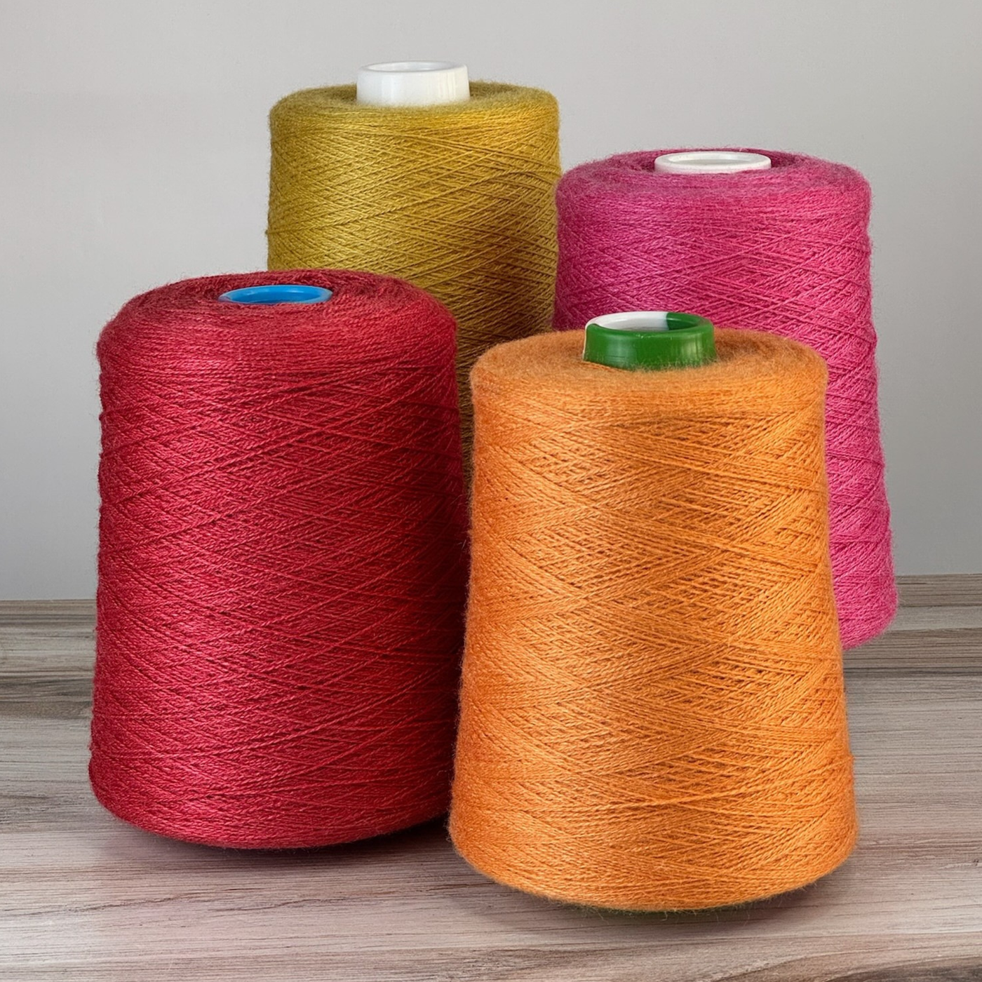 Saturated red, pumpkin, and golden cones with upright stance; 1 lb. cones, 2/18 lace (4455 yards), lustrous blend for strong warps.