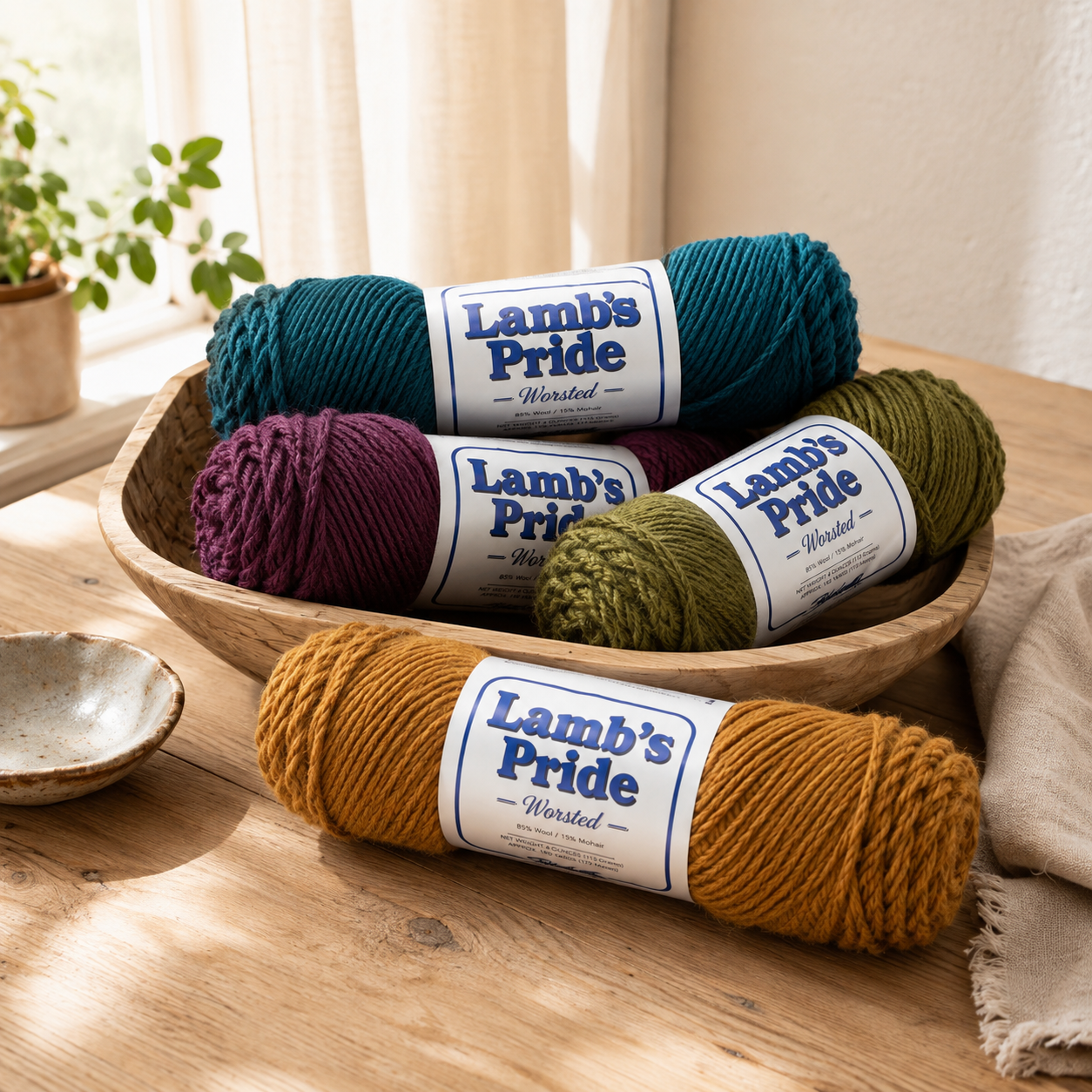 Four colorful Brown Sheep Lamb’s Pride skeins arranged in a woven basket as an example Mystery Yarn Pack assortment.