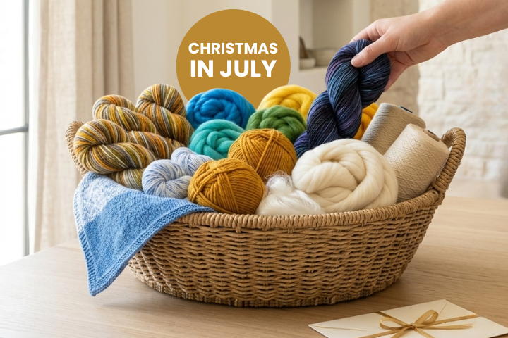 Christmas in July promotion banner showing a basket of yarn and fiber with a bonus gift card offer