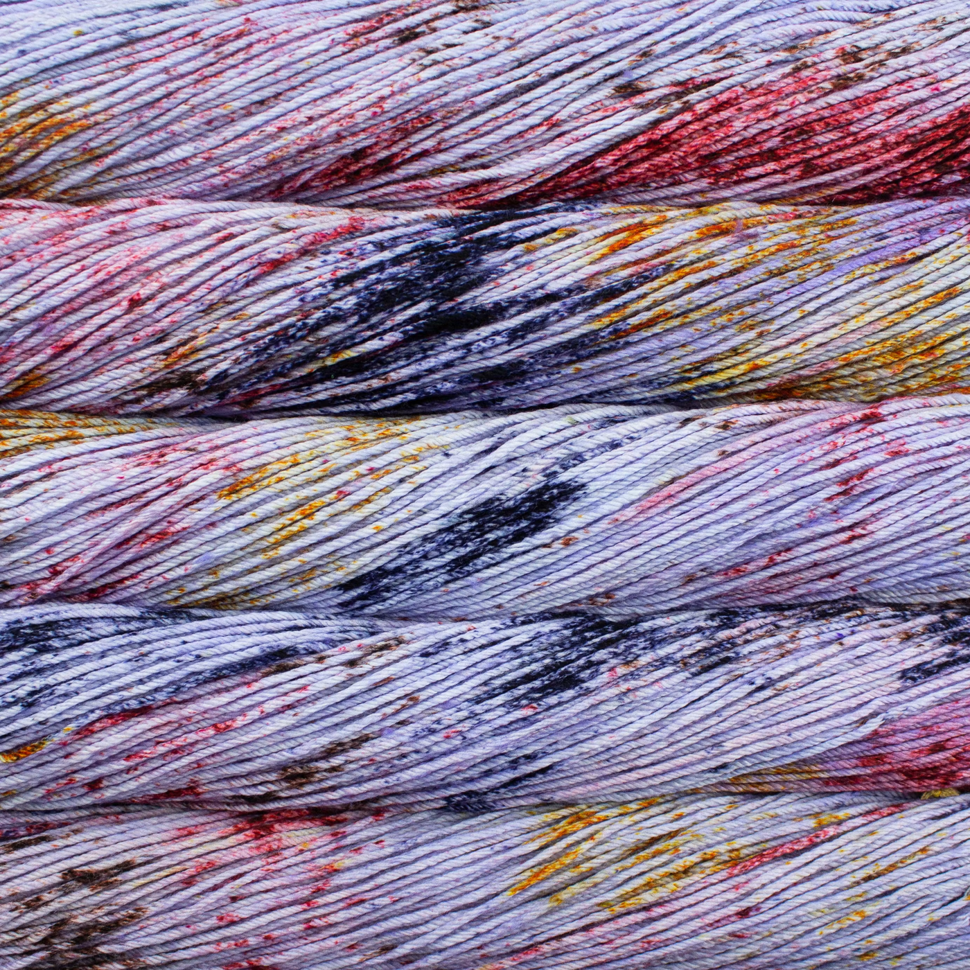 Malabrigo Rios hand-dyed worsted yarn in Medusa RIO276, with pale lavender, gray, blue, and colorful speckled accents.