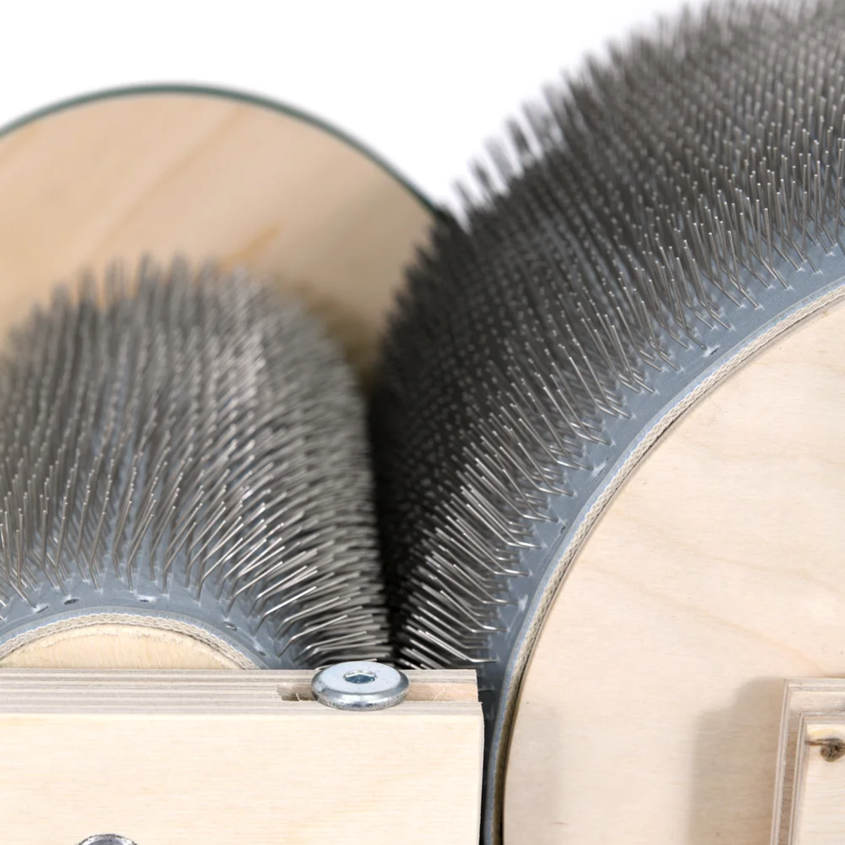 Detailed view of the Golden Fleece drum carder's steel carding teeth on the main drum and licker-in.