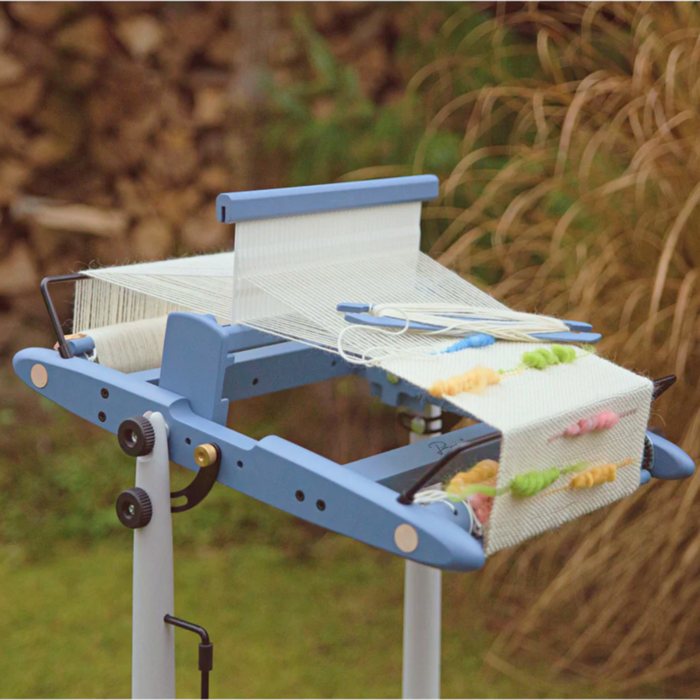 A 10" Kromski Presto Rigid Heddle Loom in the limited edition Harbor Blue colorway with warp ready for outdoor weaving.