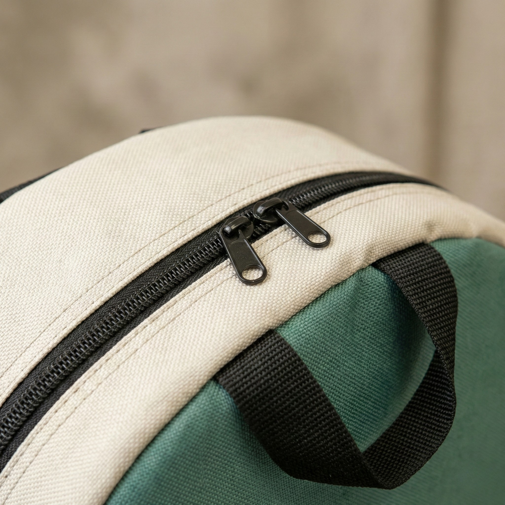 Close-up of the Kromski Sonata bag showing the heavy-duty zipper, stitching, and black webbing straps on the padded travel bag.