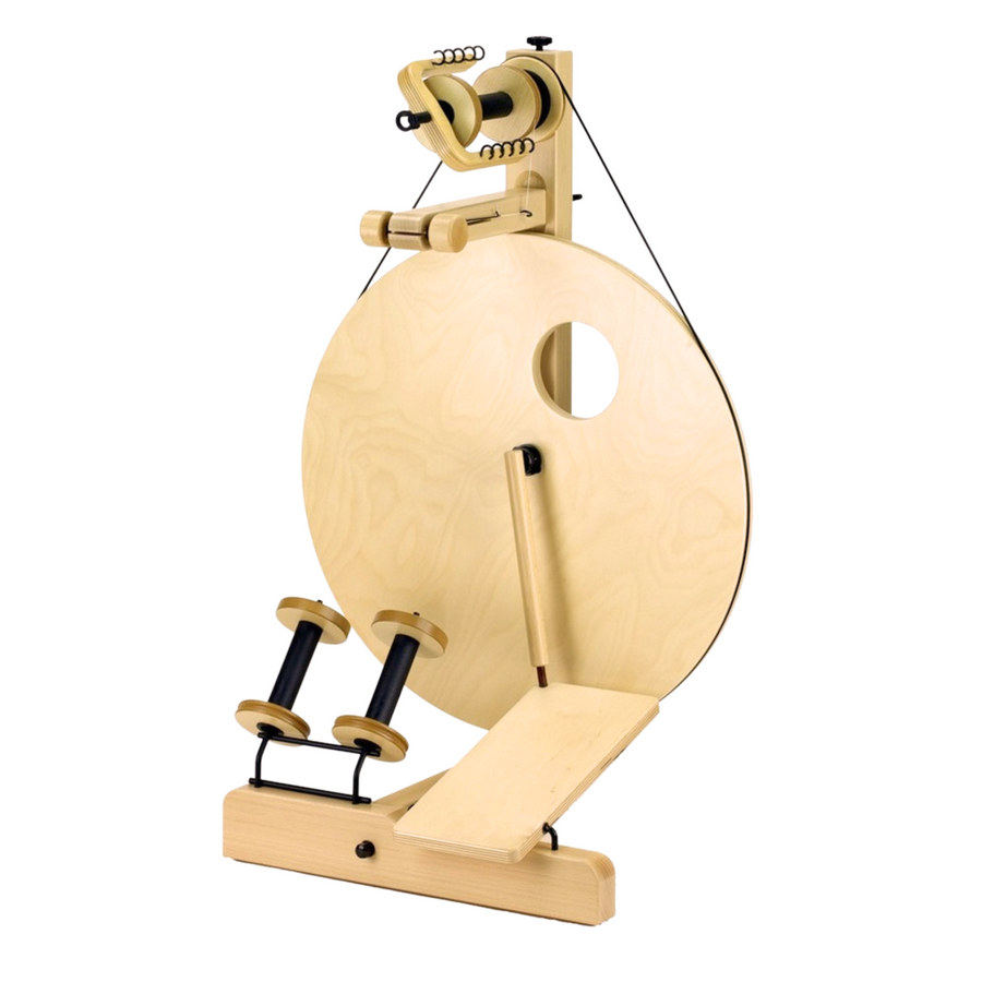 Front view of Louet S10 Single Treadle Spinning Wheel with included bobbins on lazy kate, showcasing the classic Irish tension system and large drive wheel.