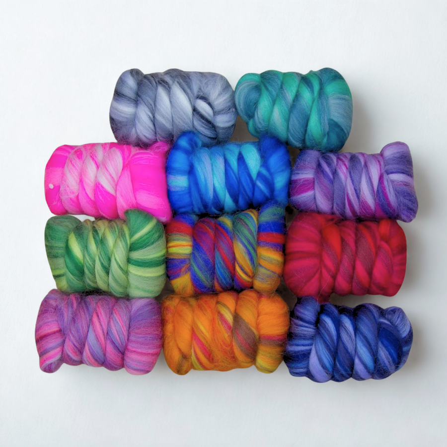 Luminoso merino wool top pack displayed in grid—vibrant multi-color fiber for spinners & felters