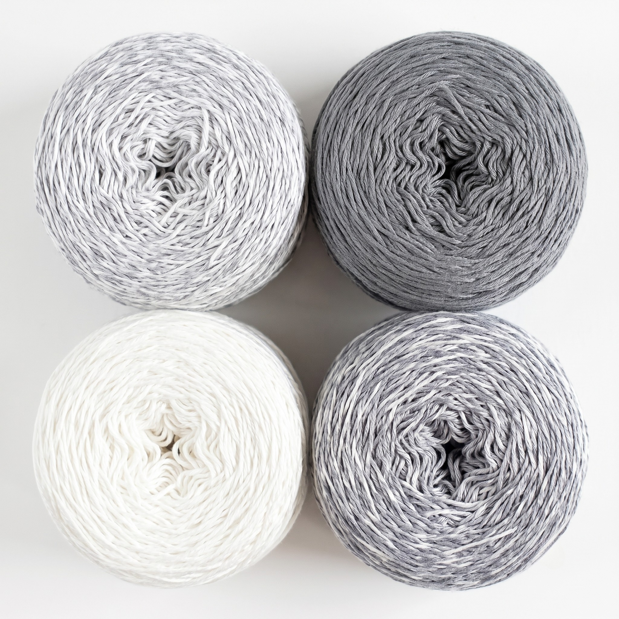 Revolution Fibers Baby Bloom Gradient Baby Blanket Kit Helios Gray yarn cakes shown from above in a 2x2 grid.