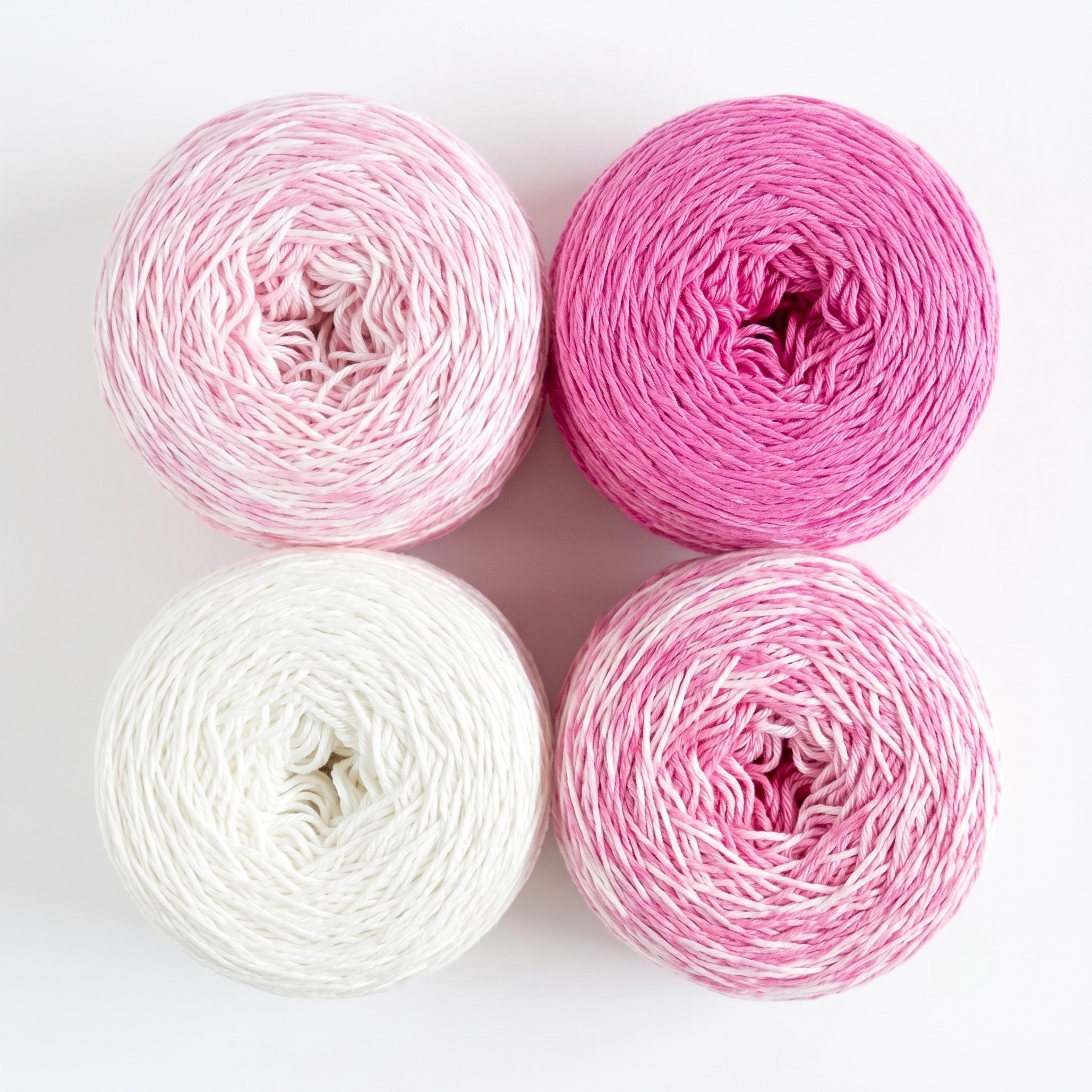 Revolution Fibers Baby Bloom Gradient Baby Blanket Kit Pink Flamingo yarn cakes shown from above in a 2x2 grid.
