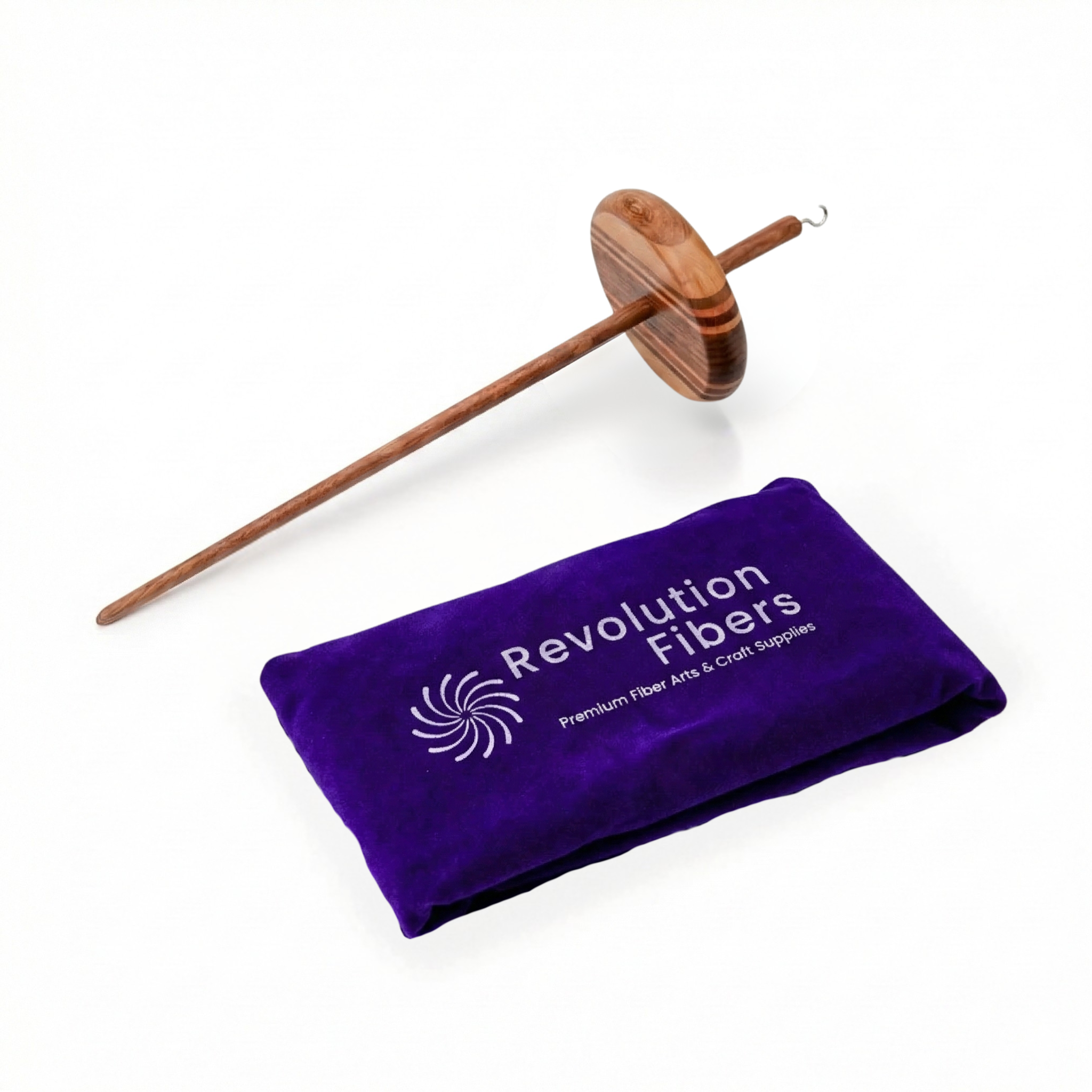 Flat lay of top whorl drop spindle with purple velvet carrying case; multi-wood wavy whorl and metal hook, studio photo on white background