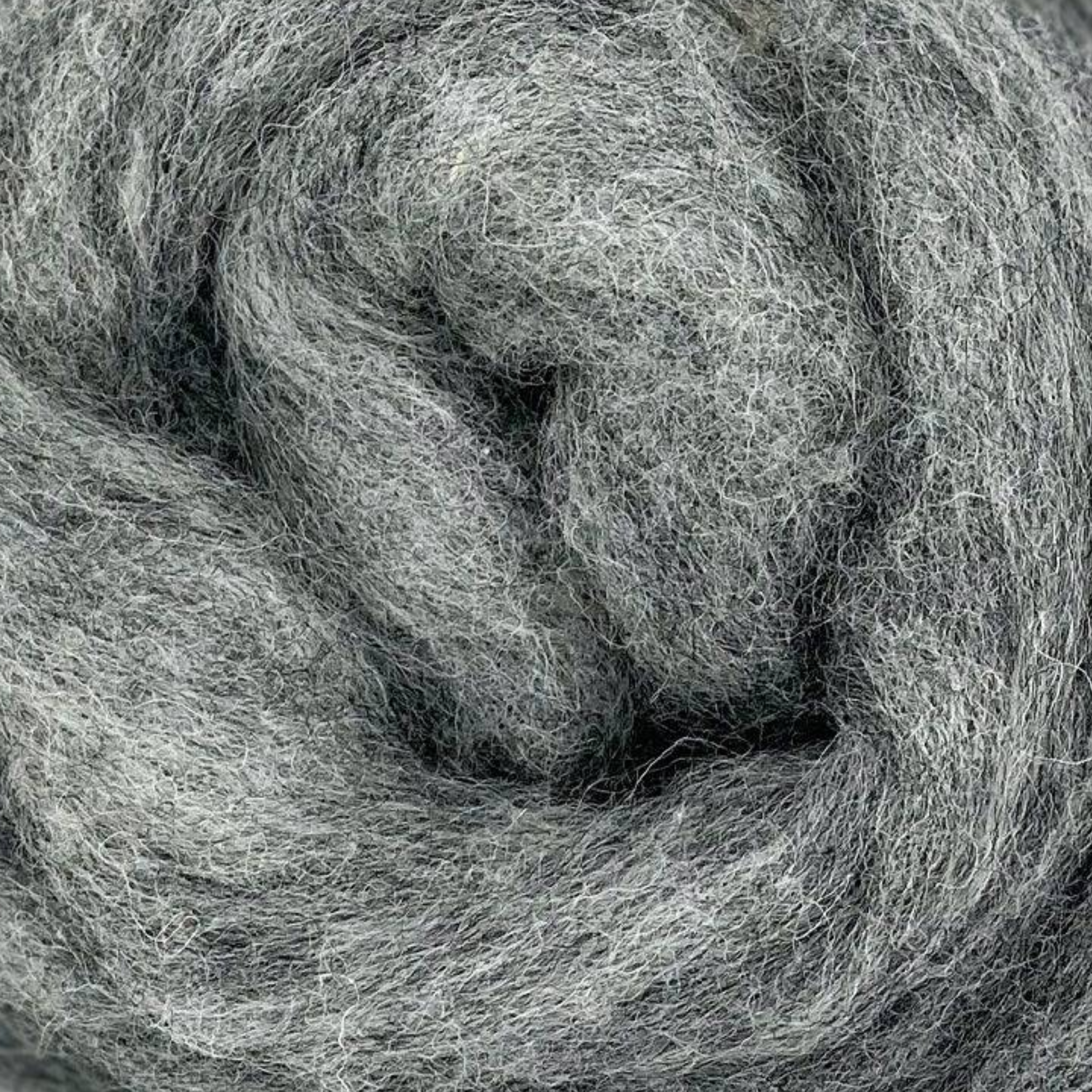 Close-up of Fog colorway from Revolution Fibers Grey Spectrum Corriedale Wool Sliver, soft heathered gray fiber for felting, blending, and hand spinning.