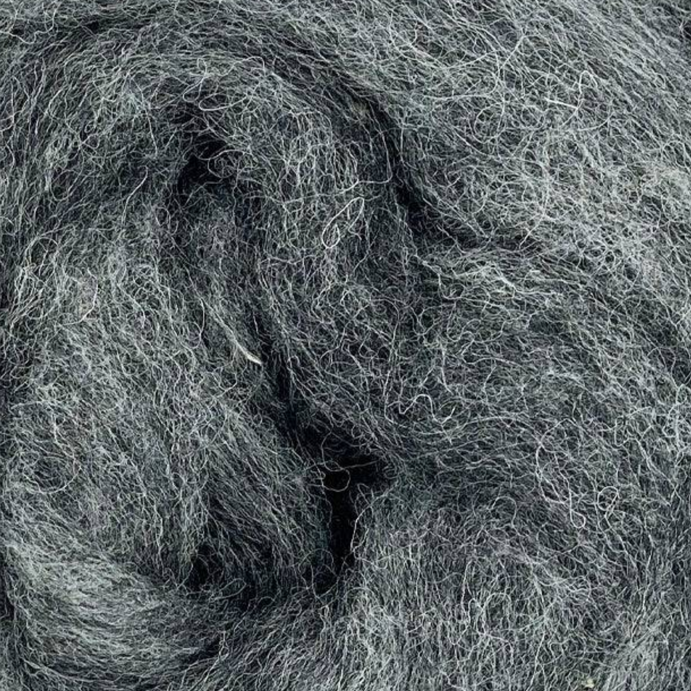 Tornado colorway close-up from Revolution Fibers Grey Spectrum Corriedale Wool Sliver, mid-tone cool gray wool fiber for felting, needle felting, and spinning.