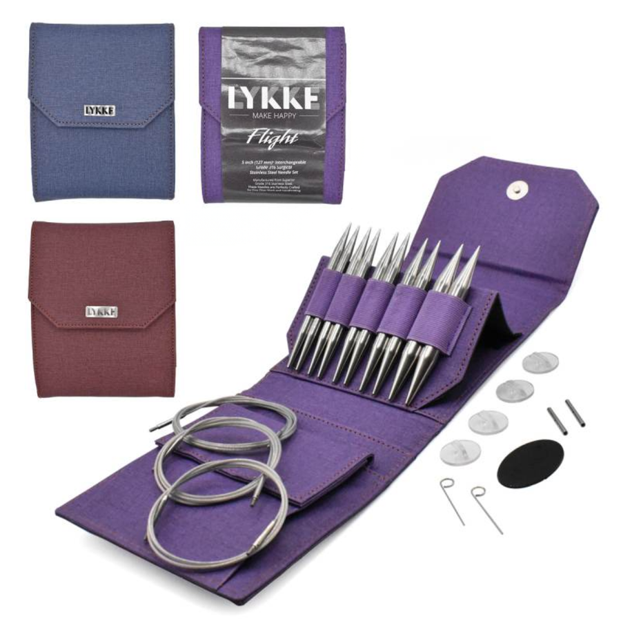 Group image of Revolution Fibers Lykke Flight 5" Bulky interchangeable stainless steel knitting needle sets showing denim, maroon and purple cases with large tips, long cords and accessories on a white background.
