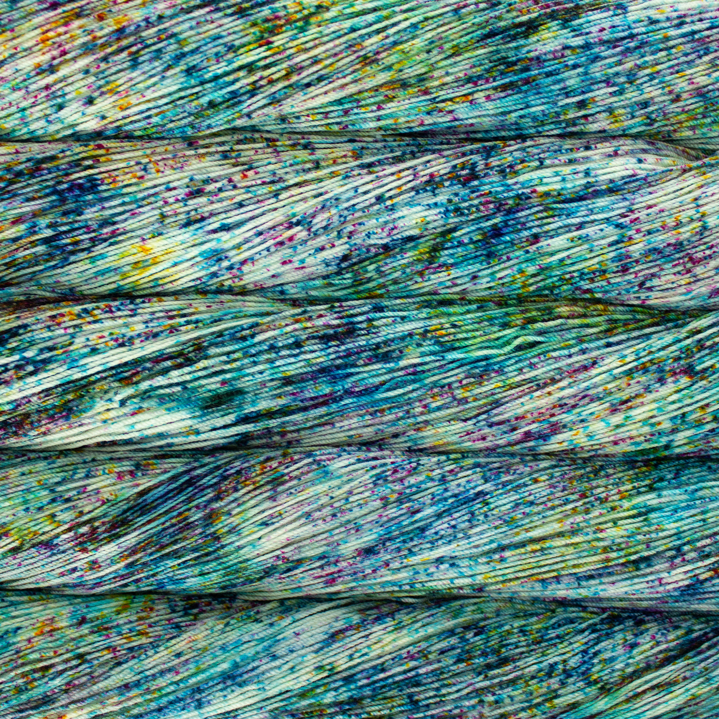 Malabrigo Sock Yarn Parade SW732 – Rainbow-speckled fingering yarn by Revolution Fibers.