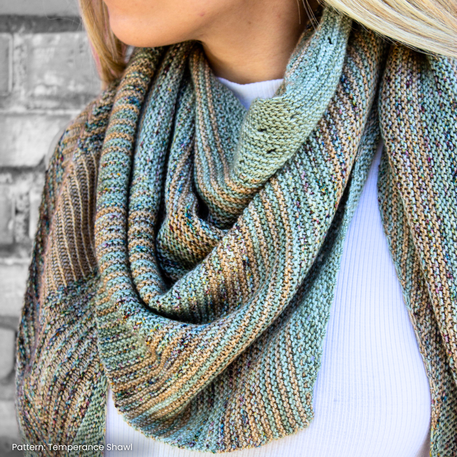 A close up of a beautifully knit Temperance Shawl featuring Malabrigo Sock yarn.
