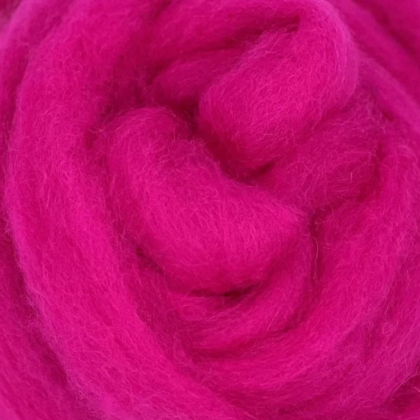 Raspberry pink Retro Pop Corriedale wool sliver by Revolution Fibers, close-up texture, ideal for felting, spinning, punch needle, and vibrant fiber crafts