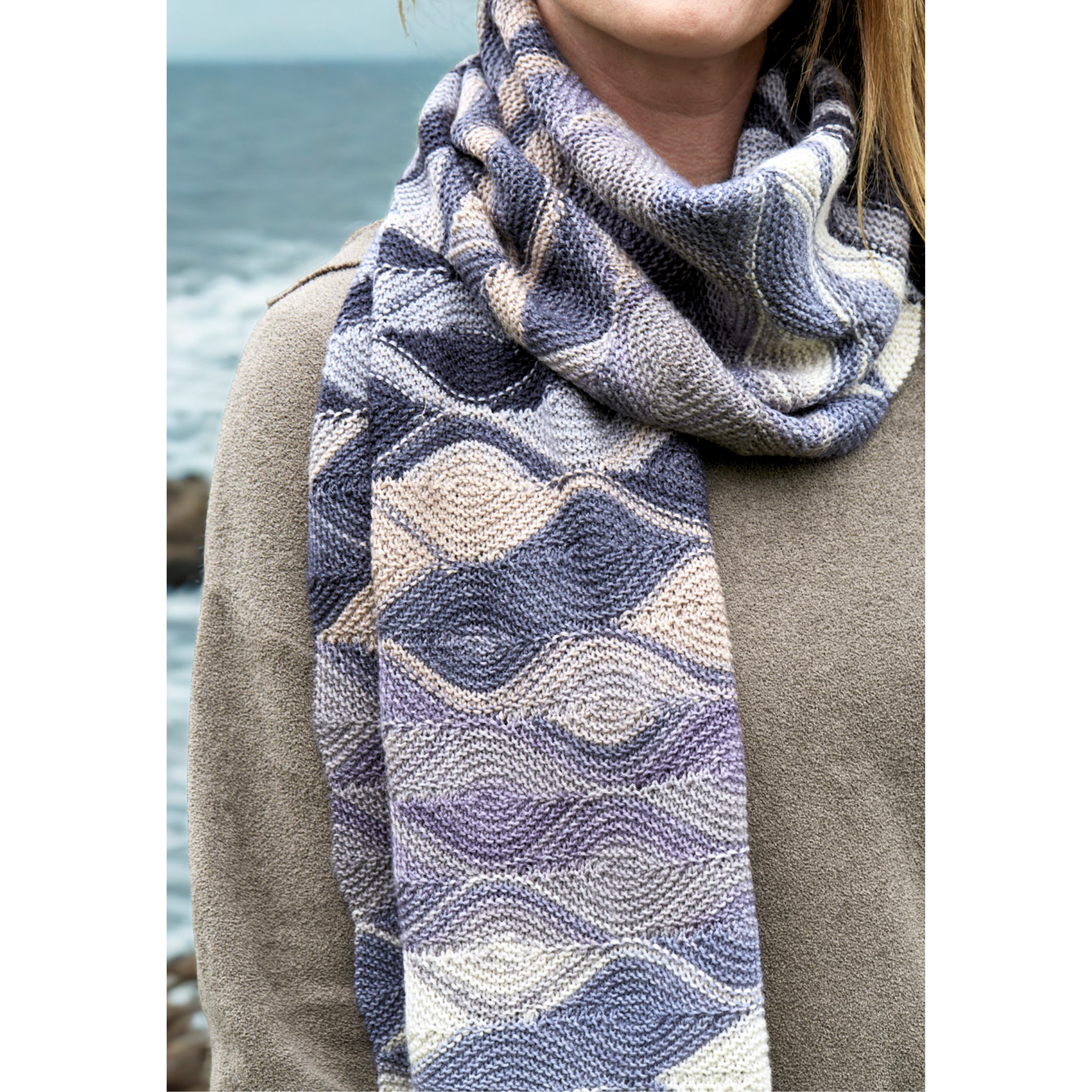 Neck-wrapped view of Hera Scarf knit with Uneek 3033, showing reversible wave motif in muted purples and greys.