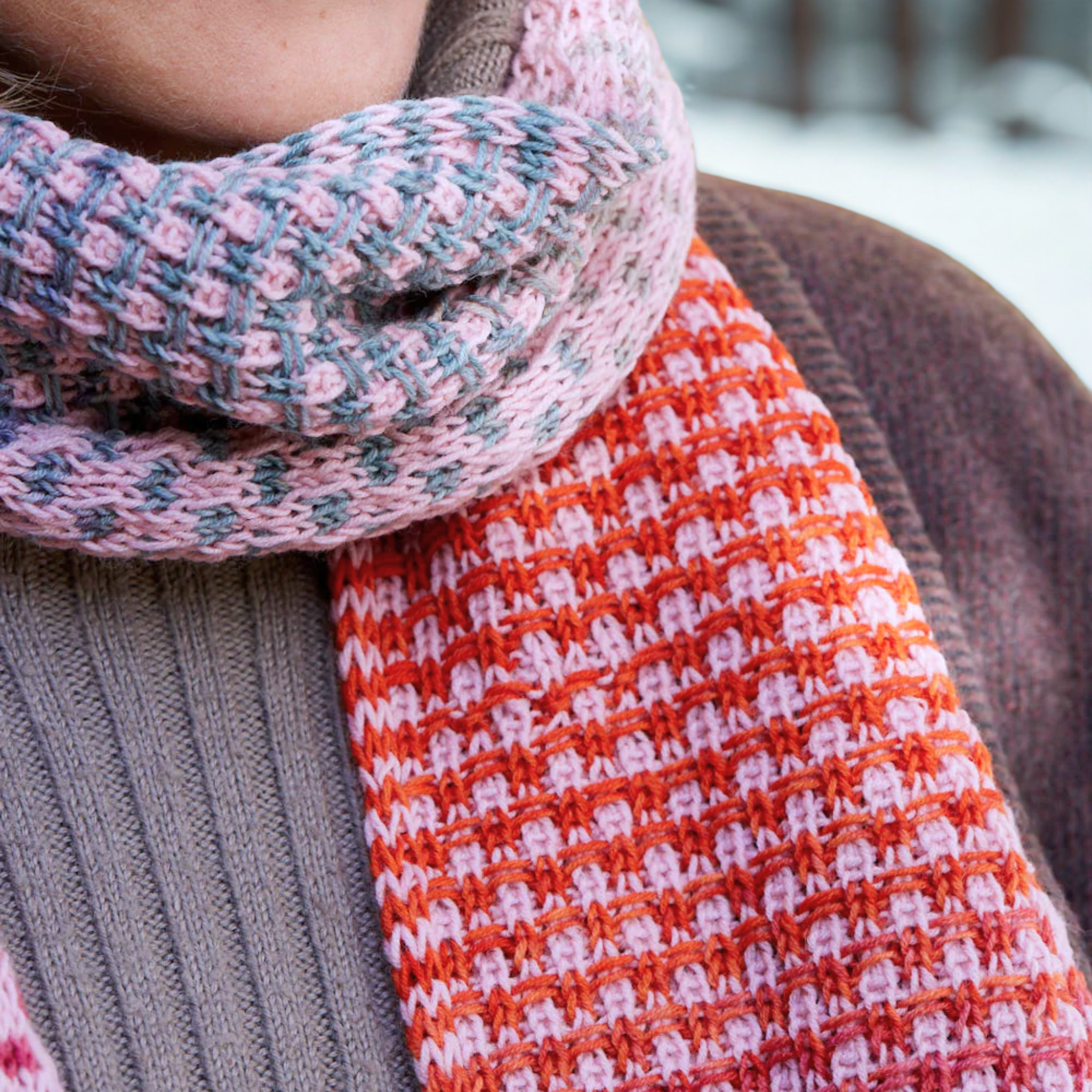 Close-up of Saman Scarf texture showing the slip-stitch bricks in Echoes 1519 and solid Core 1033 wrapped snugly around the neck.