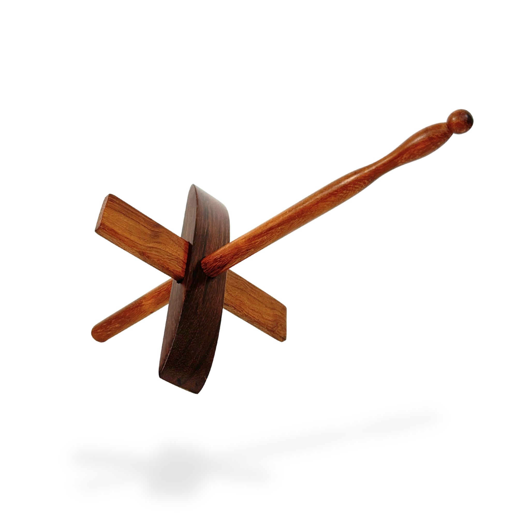 Three‑quarter floating view of Turkish drop spindle with a subtle ground shadow, highlighting lightweight, balanced construction.