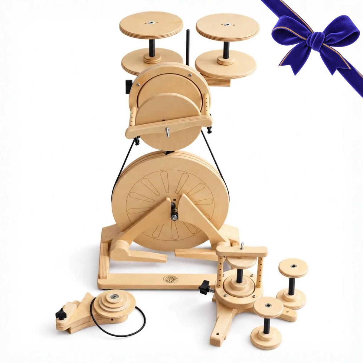 SpinOlution Pollywog Holiday Bundle featuring a wooden spinning wheel, bobbins, accessories, and an indigo holiday bow on a white background.