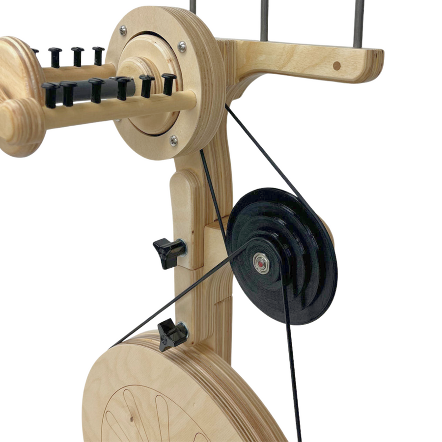 SpinOlution's New, as of July 2025, black 3D printed accelerator attached to the SpinOlution Pollywog Spinning Wheel. Front view.